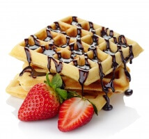 Freshly baked belgium waffles with chocolate sauce and strawberries isolated on white background